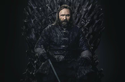 Sandor Clegane from Game of Thrones sits grim-faced on the Iron Throne in a moody 2K Quad HD PC desktop wallpaper.