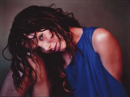 HD desktop wallpaper featuring a close-up portrait of celebrity Sandra Bullock with tousled hair and a blue sleeveless top against a dark background.