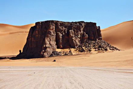 A striking 4K Ultra HD image of a rugged rock formation in the Sahara Desert’s sand dunes, located in Algeria’s Hoggar Mountains near Tassili N'Ajjer.