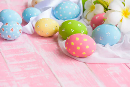Pastel decorated Easter eggs and frangipani blossoms on a white cloth over pink wooden boards — Easter holiday 5K Ultra HD PC desktop wallpaper/background.