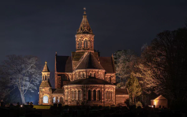 HD PC desktop wallpaper of a beautifully illuminated historic church at night, showcasing intricate religious architecture against a dark sky.