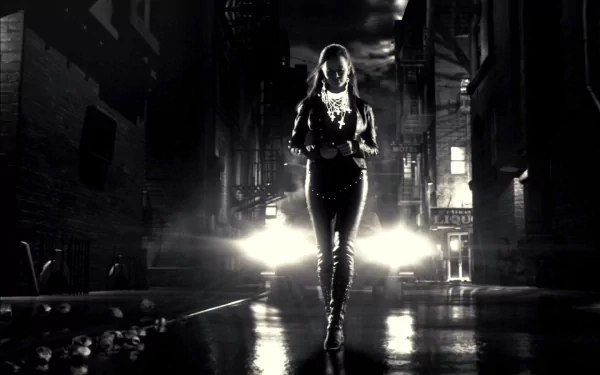 Sin City movie HD PC desktop wallpaper/background: monochrome scene of a lone woman in leather striding down a rain-slick alley toward glaring car headlights.