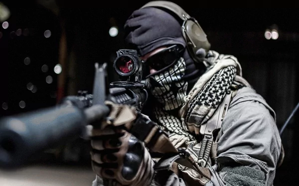 HD desktop wallpaper featuring a military soldier aiming a rifle, wearing tactical gear and a face covering with a skull graphic.