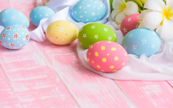 Pastel decorated Easter eggs and frangipani blossoms on a white cloth over pink wooden boards — Easter holiday 5K Ultra HD PC desktop wallpaper/background.