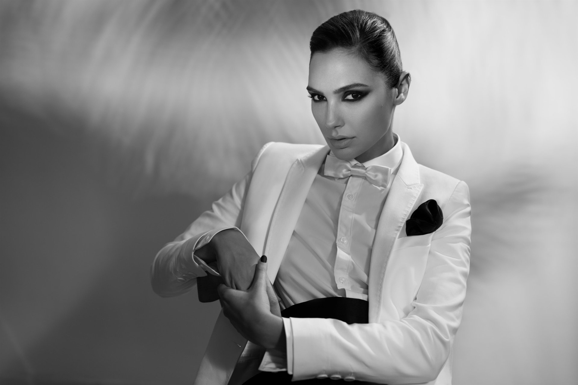 Black and white 4K Ultra HD portrait of Israeli actress and model Gal Gadot in a stylish tuxedo, exuding celebrity elegance and confidence.