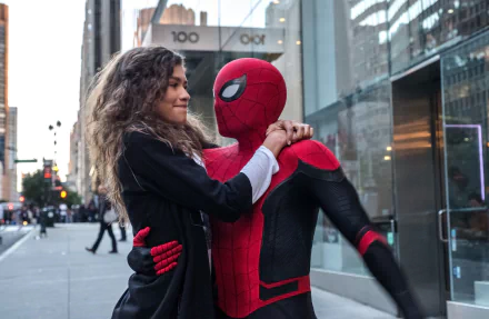 Peter Parker (Tom Holland) as Spider-Man stands with Michelle 'MJ' Jones (Zendaya) in a city setting from the movie Spider-Man: Far From Home. HD desktop wallpaper with depth of field effect.