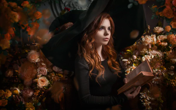 A redhead woman with long hair in a witch hat reads a book surrounded by white and peach roses, captured in a detailed 4K Ultra HD cosplay wallpaper.