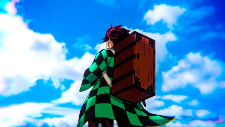 HD desktop wallpaper featuring an anime character from Demon Slayer: Kimetsu no Yaiba, wearing a green checkered haori, carrying a wooden box, and standing under a vibrant blue sky with white clouds.