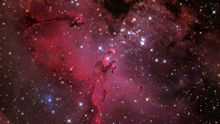 HD desktop wallpaper of the Eagle Nebula, depicting a stunning array of stars and cosmic clouds in vibrant shades of red and purple, providing a sci-fi themed background.