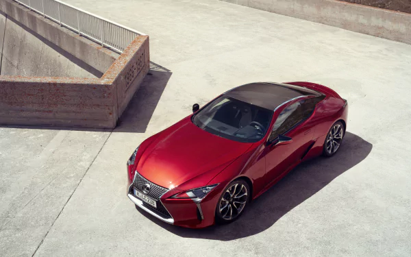 Red Lexus LC 500 sports car on sunlit concrete, photographed from above — 4K Ultra HD PC desktop wallpaper background showcasing the Lexus vehicle.