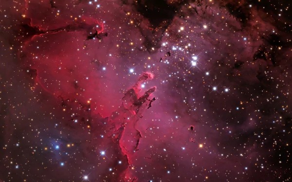 HD desktop wallpaper of the Eagle Nebula, depicting a stunning array of stars and cosmic clouds in vibrant shades of red and purple, providing a sci-fi themed background.