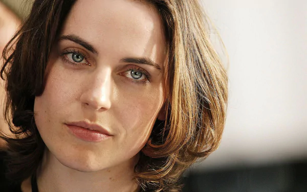 Close-up portrait of a blue-eyed woman with short brown hair and soft lighting — HD PC desktop wallpaper/background.