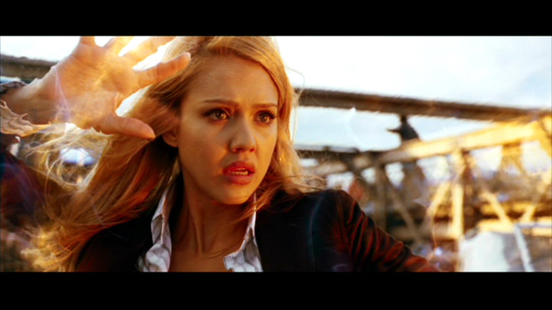 High-definition wallpaper from the movie Fantastic Four, featuring a woman with blonde hair, expressing intense emotion against a dramatic backdrop.
