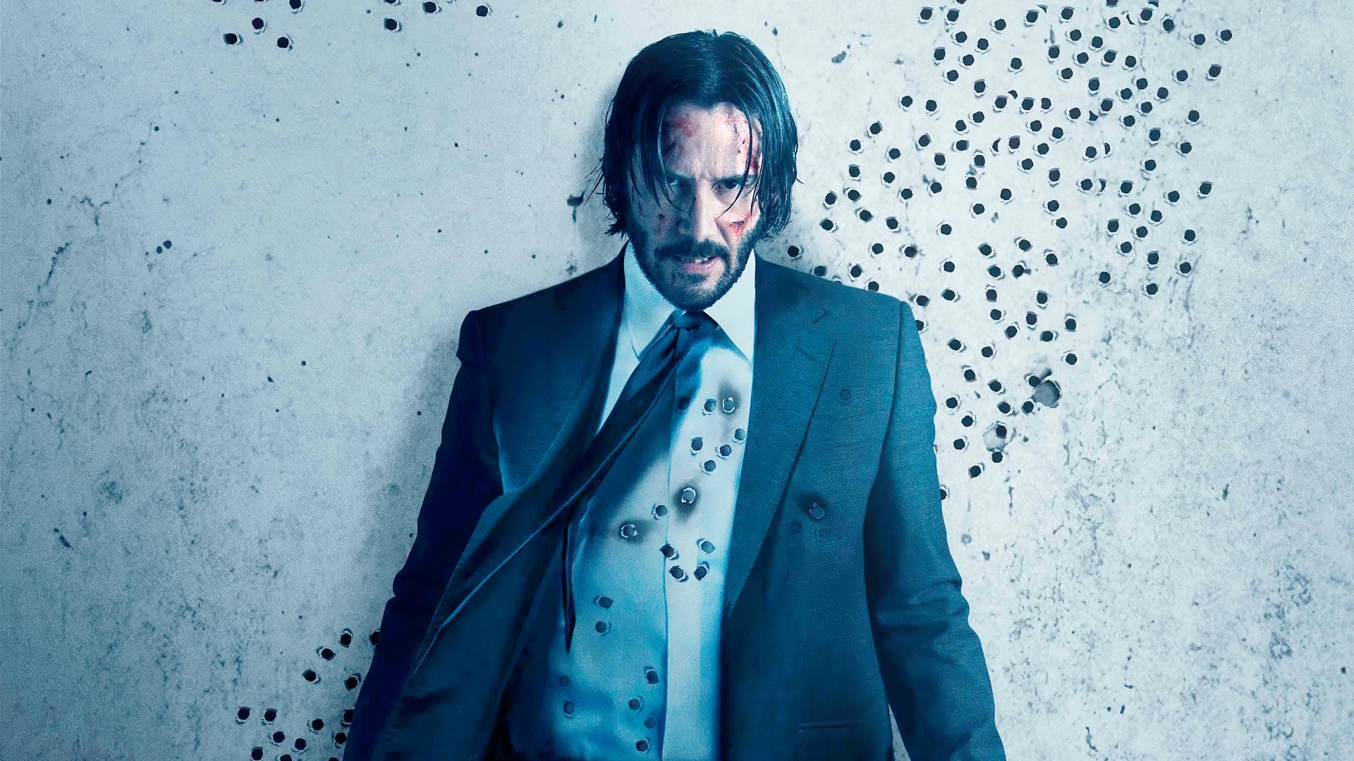 Keanu Reeves as John Wick in a dramatic 4K Ultra HD movie wallpaper from John Wick: Chapter 2, standing against a wall marked with bullet holes.