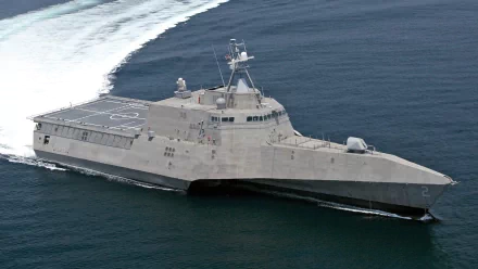 The USS Independence (LCS-2), a littoral combat ship, cuts through the waves, showcasing its sleek design and military prowess in this high-definition desktop wallpaper.