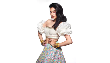 Portrait of Janhvi Kapoor, Indian Bollywood actress with black hair and brown eyes, dressed in a white puffed blouse and colorful skirt, showcased in 8K Ultra HD.