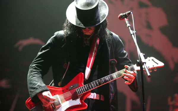 HD desktop wallpaper featuring a musician from The White Stripes playing an electric guitar on stage under dramatic lighting.