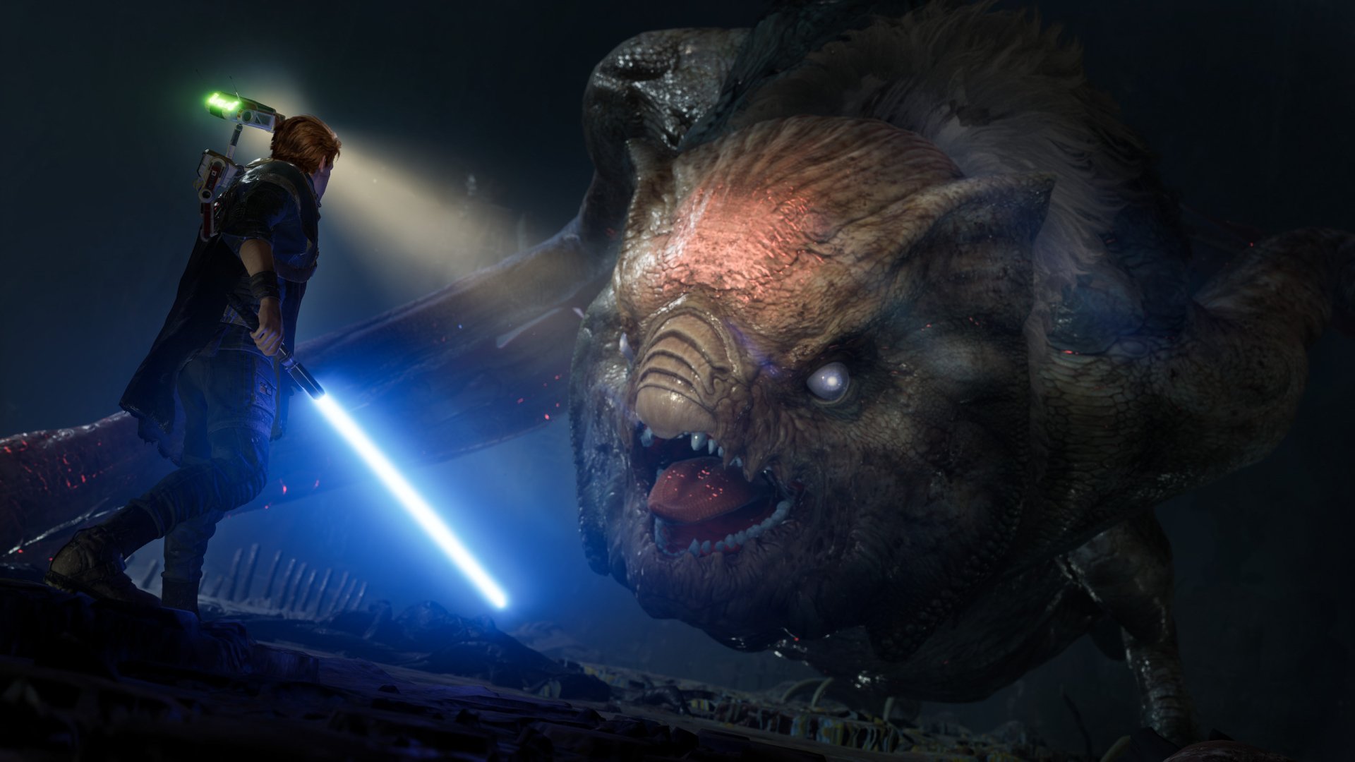 Cal Kestis, lightsaber drawn, confronts a giant reptilian beast in a dark cavern — Star Wars Jedi: Fallen Order video game 2K Quad HD PC desktop wallpaper background.