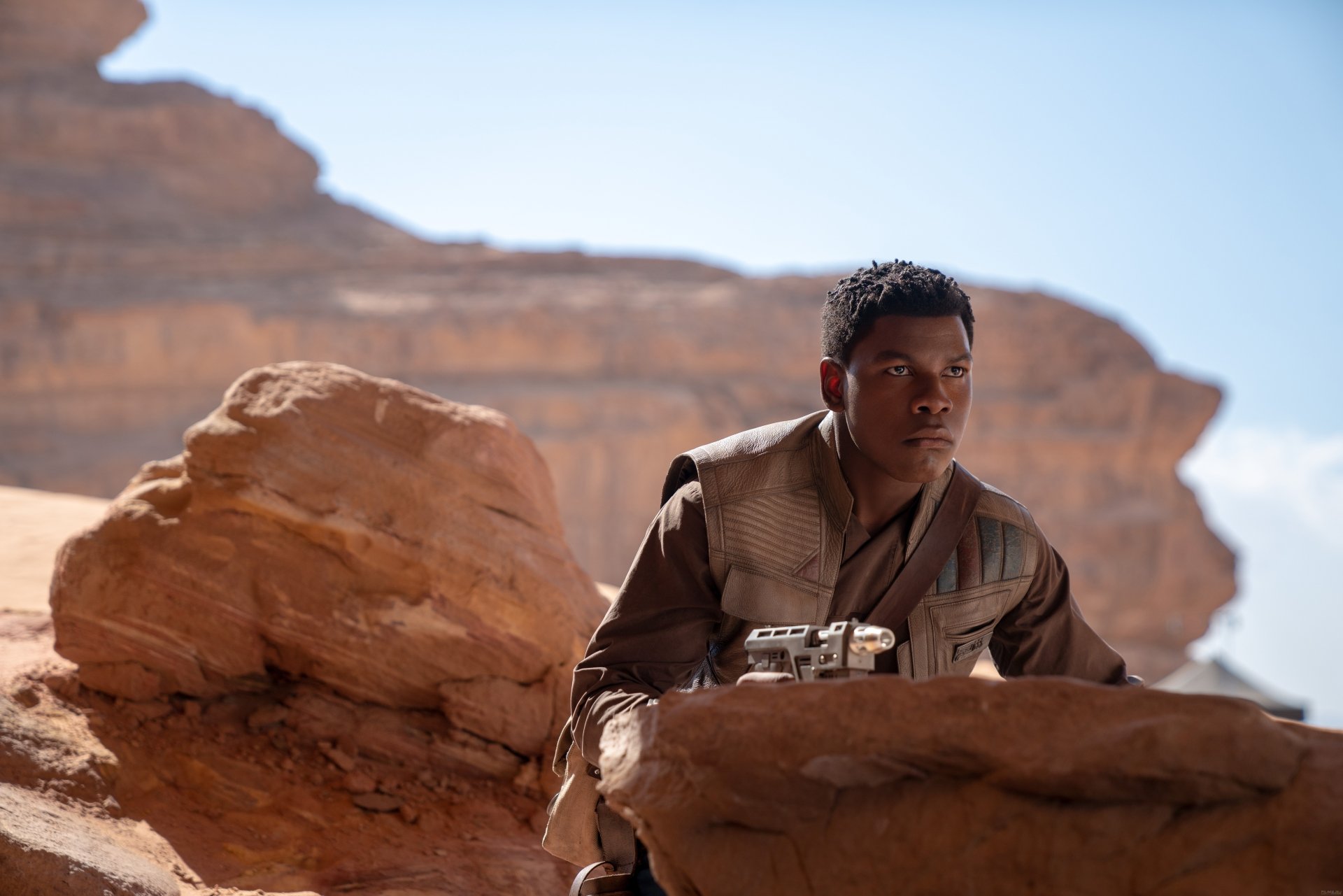 Finn, portrayed by John Boyega, is shown in a desert landscape from Star Wars: The Rise of Skywalker in this 8K Ultra HD PC desktop wallpaper and background.