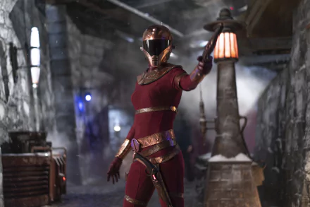 Zorii Bliss from Star Wars: The Rise of Skywalker is featured in an 8K Ultra HD PC desktop wallpaper, showcasing her striking red armor and helmet in a dimly lit setting.