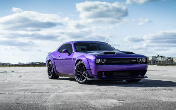 Purple Dodge Challenger muscle car on a concrete lot under a blue sky, 4K Ultra HD PC desktop wallpaper background.