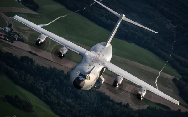 Aerial view of an Airbus A400M military transport aircraft flying over a landscape, captured in high-definition suitable for a PC desktop wallpaper.