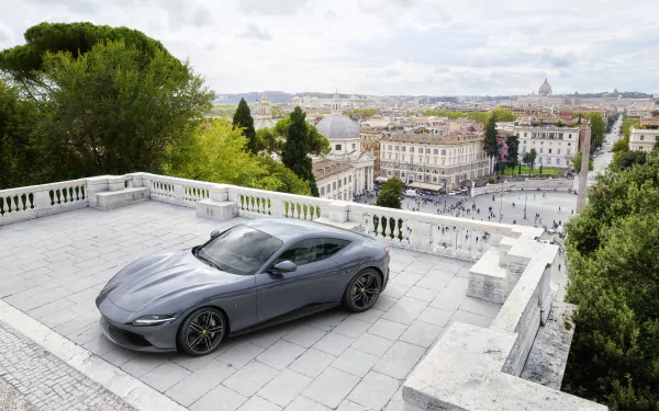 Silver Ferrari Roma supercar parked on a terrace overlooking a cityscape, captured in stunning 4K Ultra HD for a sleek PC desktop wallpaper.
