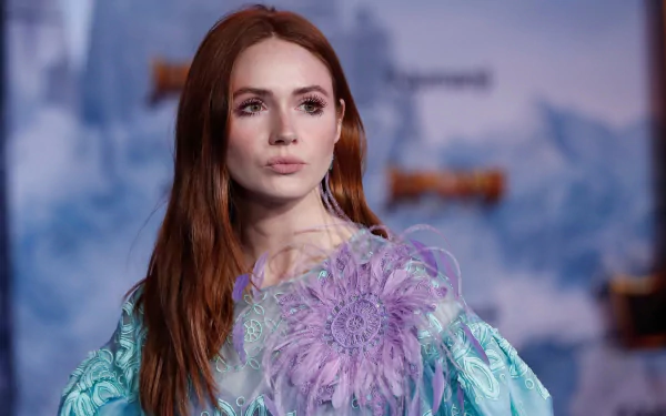 HD desktop wallpaper featuring Karen Gillan, Scottish redhead actress and model, in a vibrant, detailed purple and blue outfit against a blurred backdrop.