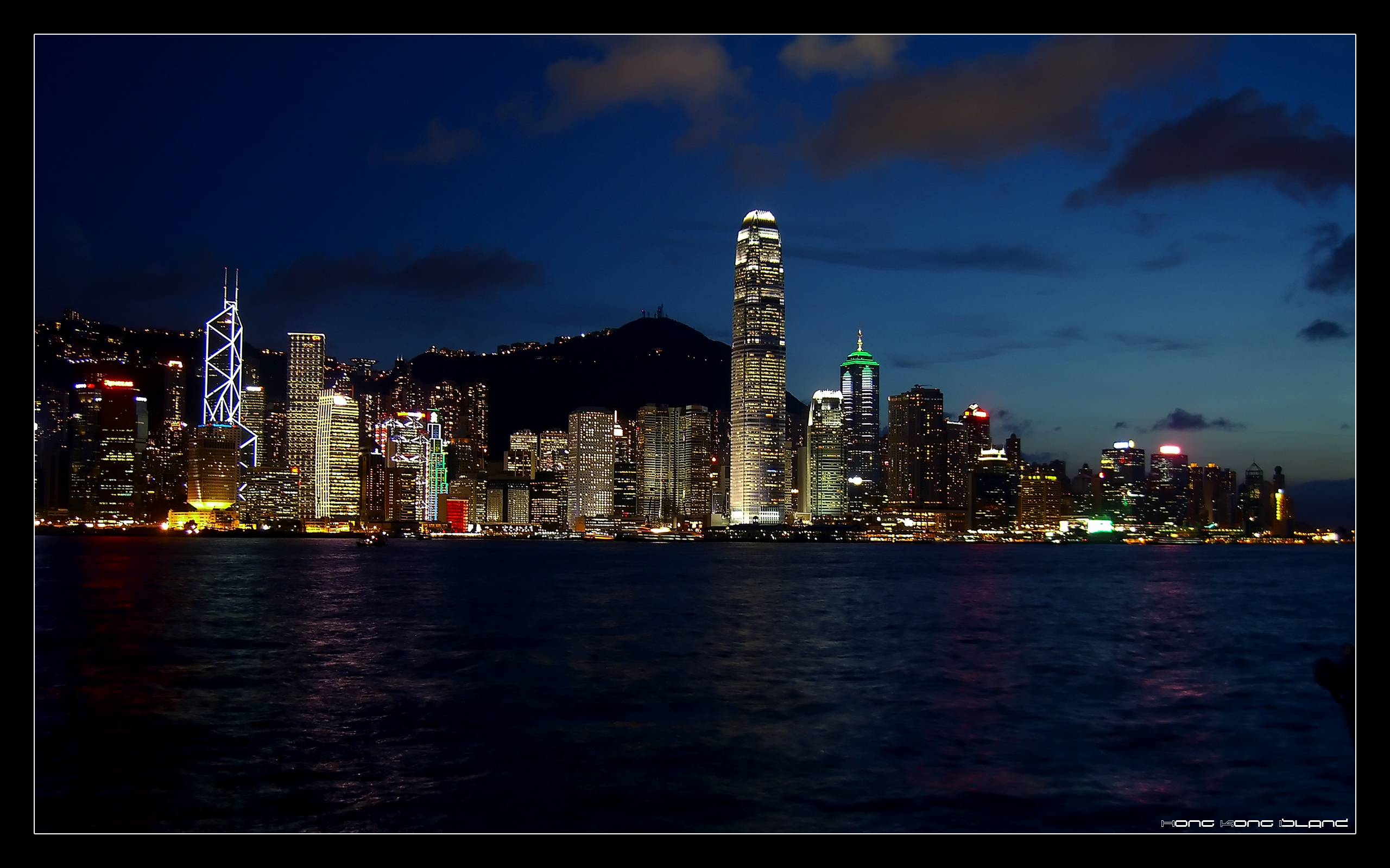 Hong Kong skyline at night with bright city lights.