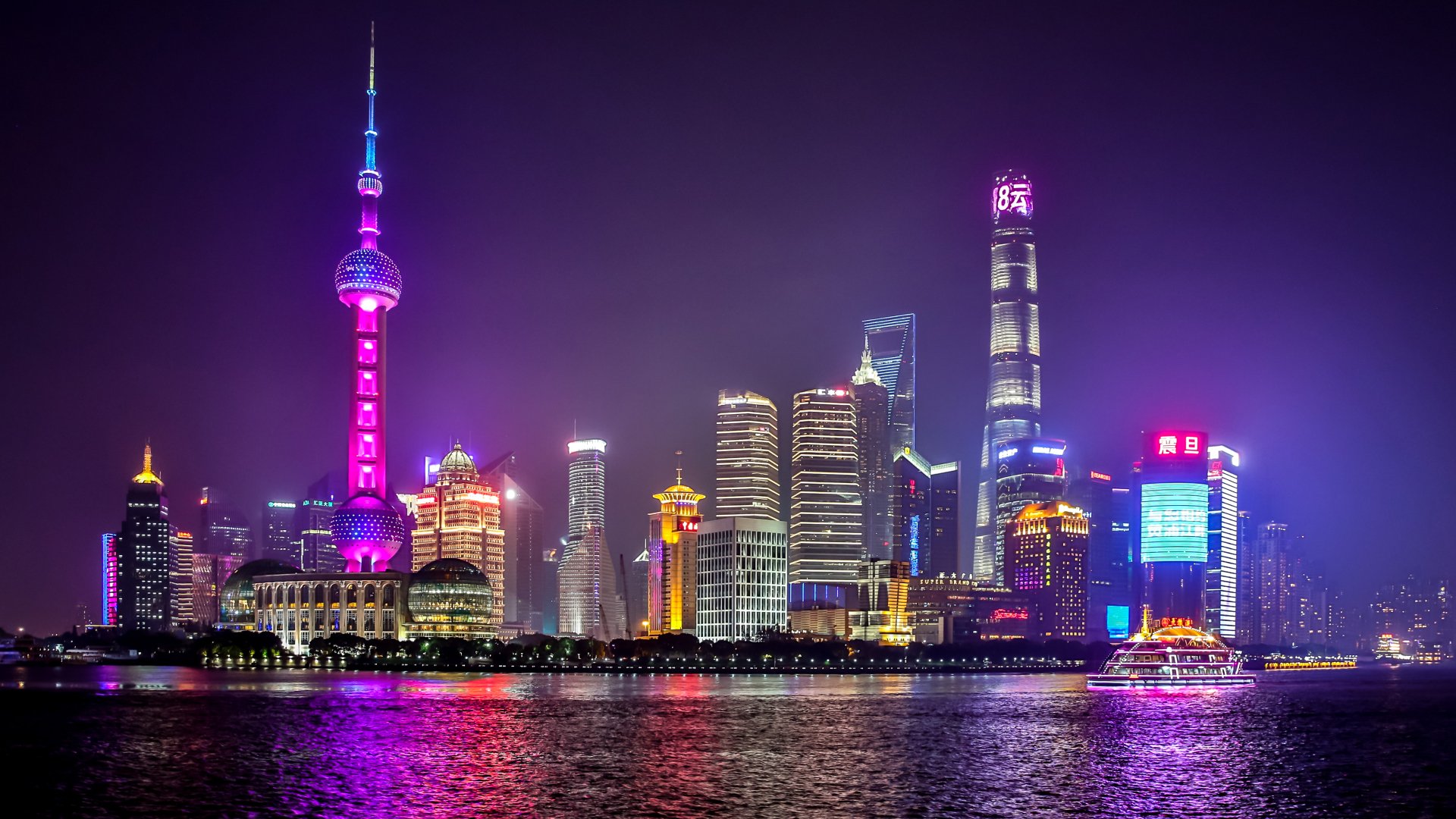 5K Ultra HD night cityscape of Shanghai with the illuminated Oriental Pearl Tower and skyscrapers reflecting on the river — vibrant man-made desktop wallpaper.
