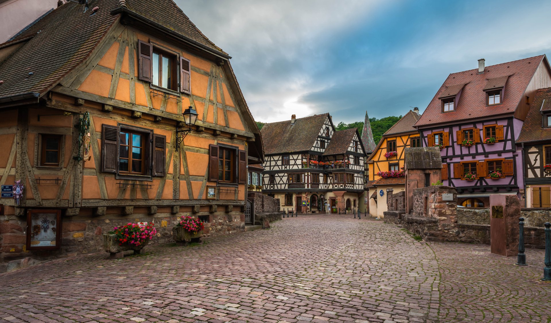 Charming cobblestone street lined with colorful half-timbered houses in Kaysersberg, Alsace, France, captured in 4K Ultra HD.