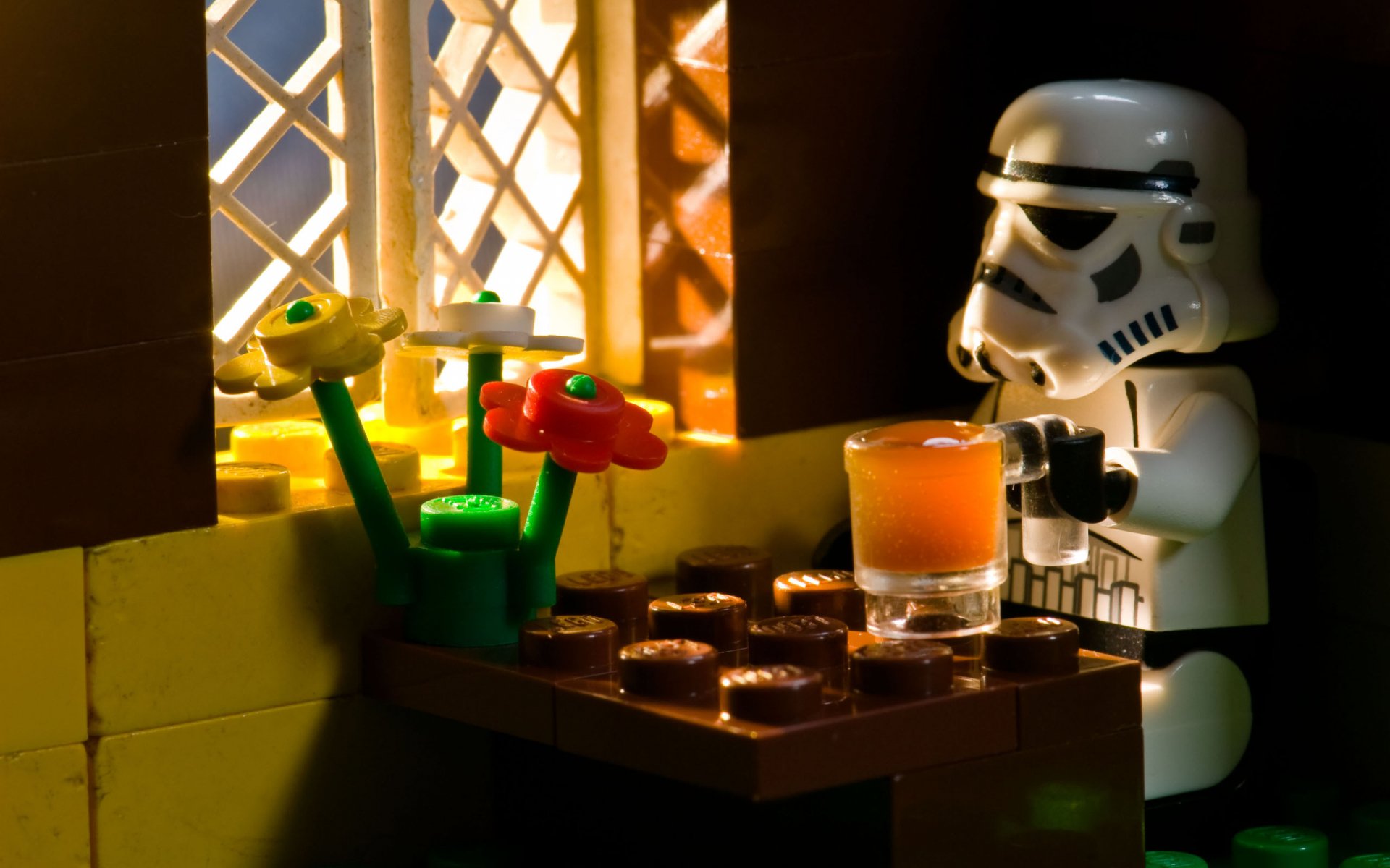 HD PC desktop wallpaper featuring a LEGO Star Wars stormtrooper standing by a window with colorful flowers on a table, blending sci-fi and playful elements.