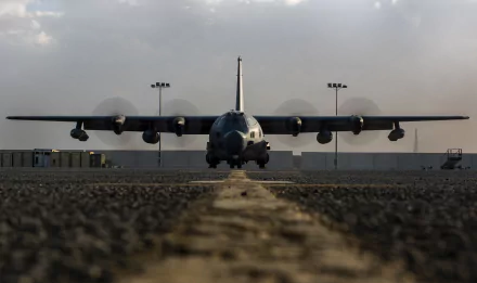 Front view of a Lockheed MC-130 military transport aircraft on runway under a cloudy sky, captured in 4K Ultra HD for a PC desktop wallpaper.