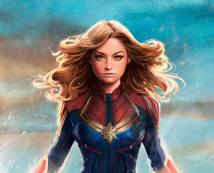HD PC desktop wallpaper of comic Captain Marvel with flowing blonde hair and brown eyes, in her red-and-blue star-emblazoned suit against a cloudy teal sky.