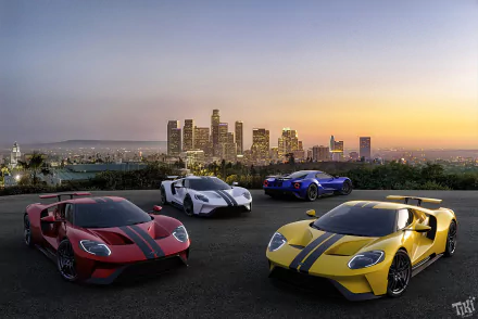 4K Ultra HD desktop wallpaper: four Ford GT supercars (yellow, white, blue, red) parked on a rooftop overlooking a city skyline at sunset.