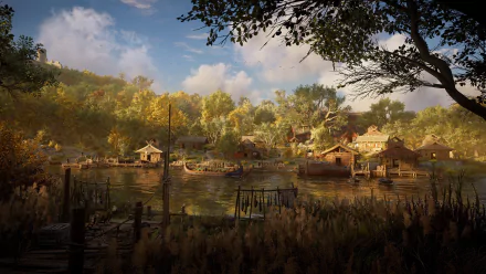 4K Ultra HD PC desktop wallpaper from the video game Assassin's Creed Valhalla — riverside Viking village at golden hour with boats, thatched houses and autumn woodland under a blue sky.
