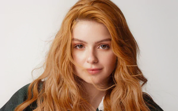Close-up portrait of redhead actress Ariel Winter with brown eyes, captured in 4K Ultra HD for a PC desktop wallpaper and background.