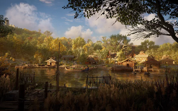 4K Ultra HD PC desktop wallpaper from the video game Assassin's Creed Valhalla — riverside Viking village at golden hour with boats, thatched houses and autumn woodland under a blue sky.