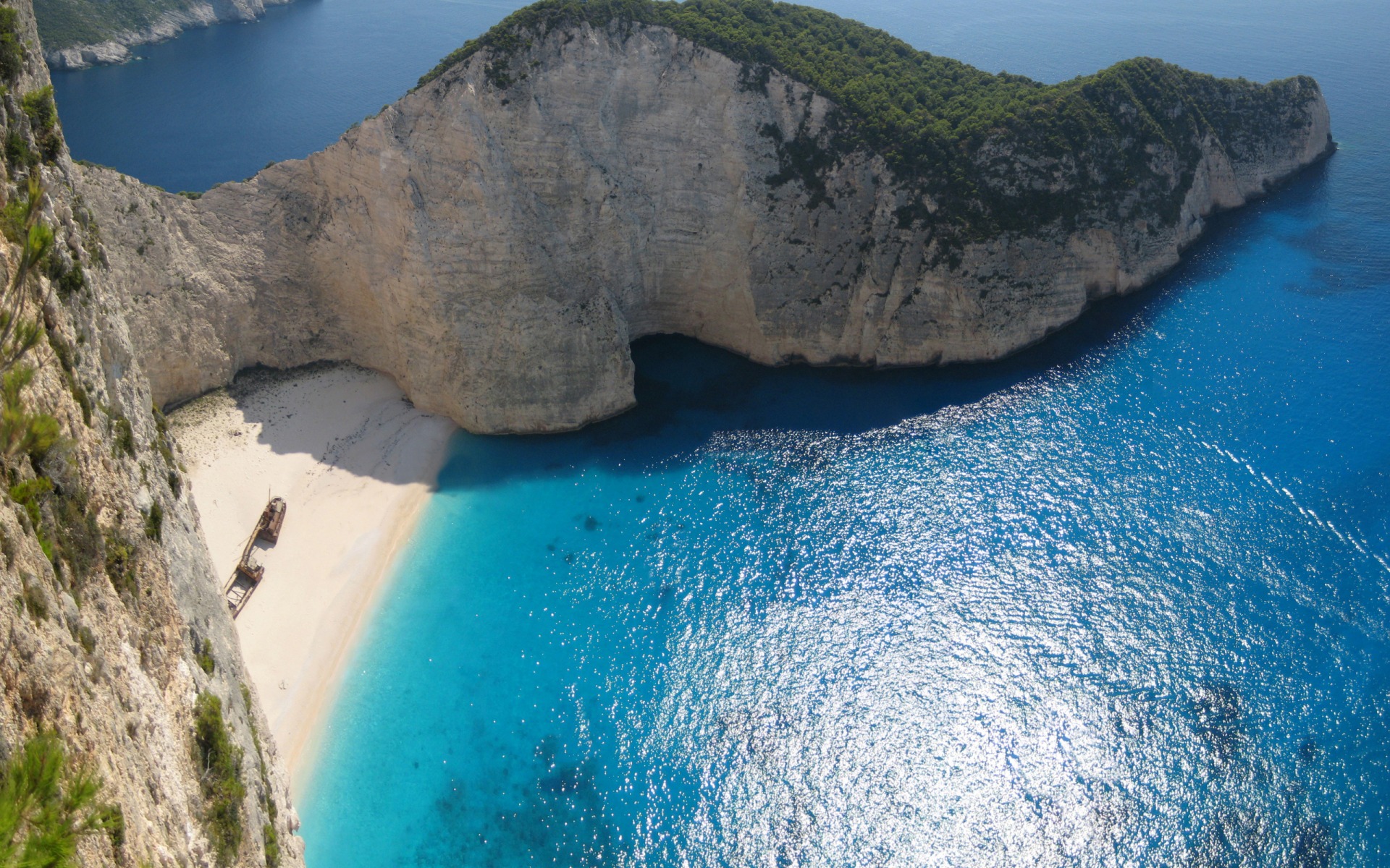 Zakynthos island beach with dramatic cliffs and clear turquoise sea in Greece.