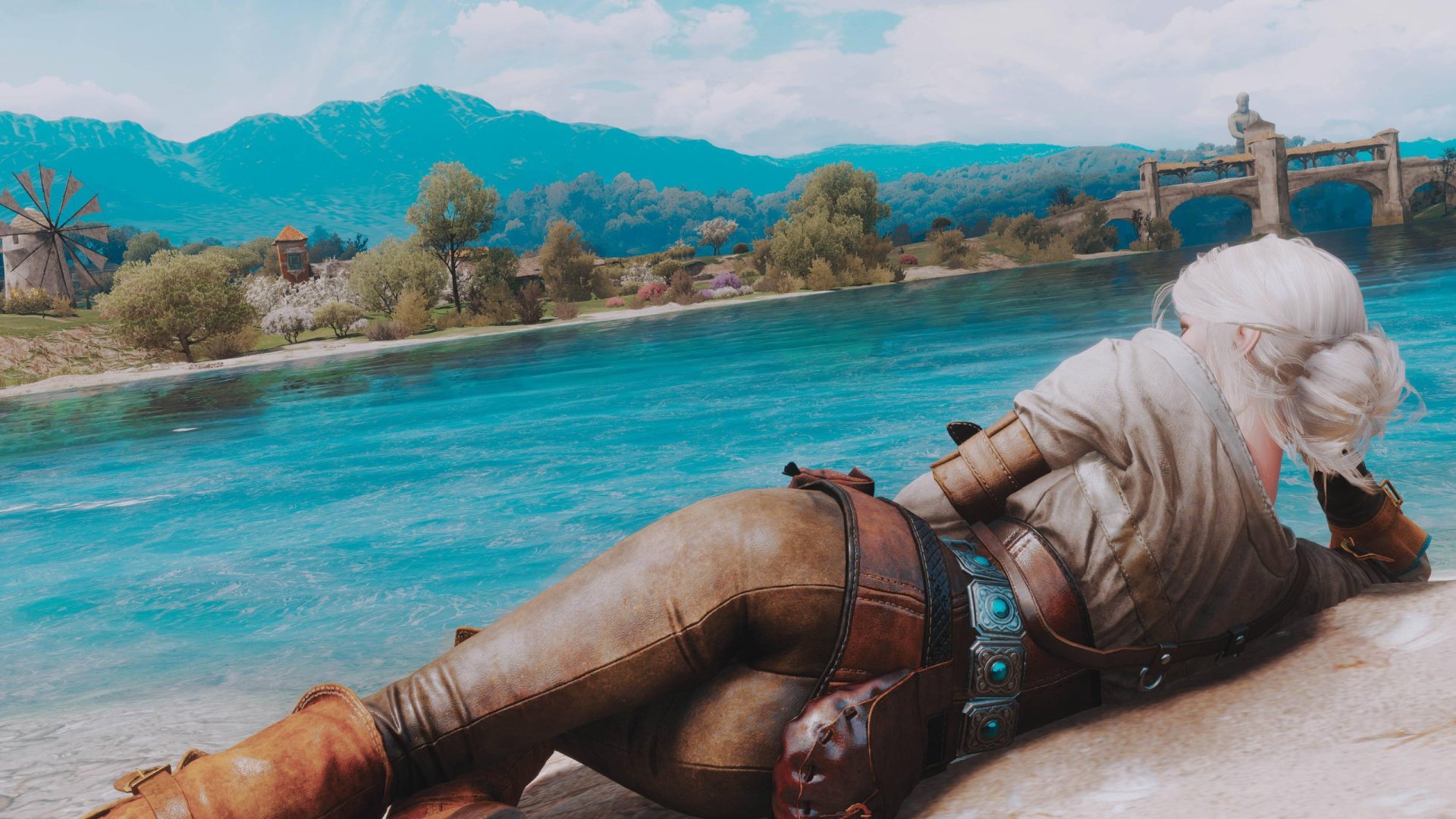 Ciri from The Witcher 3: Wild Hunt lounges by a serene riverside in this HD PC desktop wallpaper from the video game.