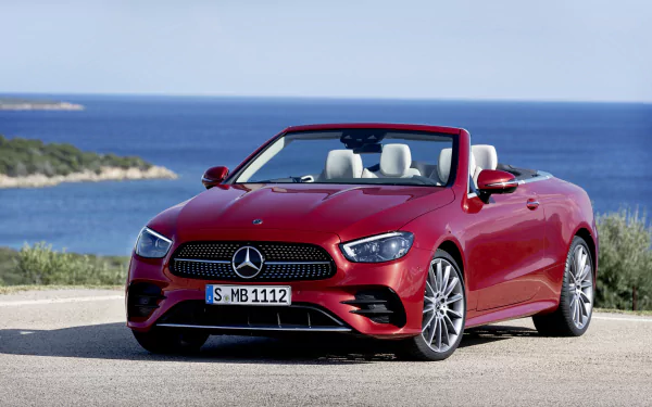Red Mercedes‑Benz E‑Class (E 450) cabriolet parked by the sea — convertible car/vehicle shown as an 8K Ultra HD PC desktop wallpaper and background.