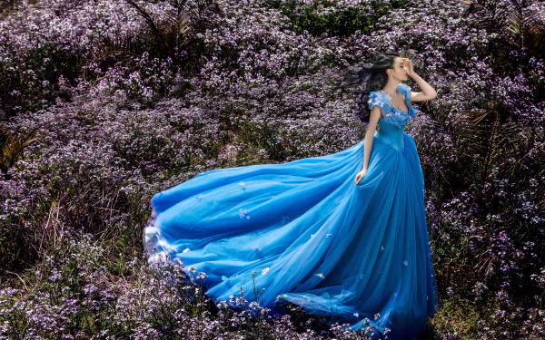  Woman in Blue Dress among Flowers