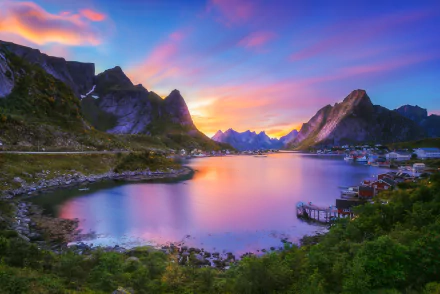 HD desktop wallpaper of Reine, Norway, capturing a serene lake with clear reflections of island mountains during sunset. This stunning Lofoten photography depicts vibrant, colorful skies.