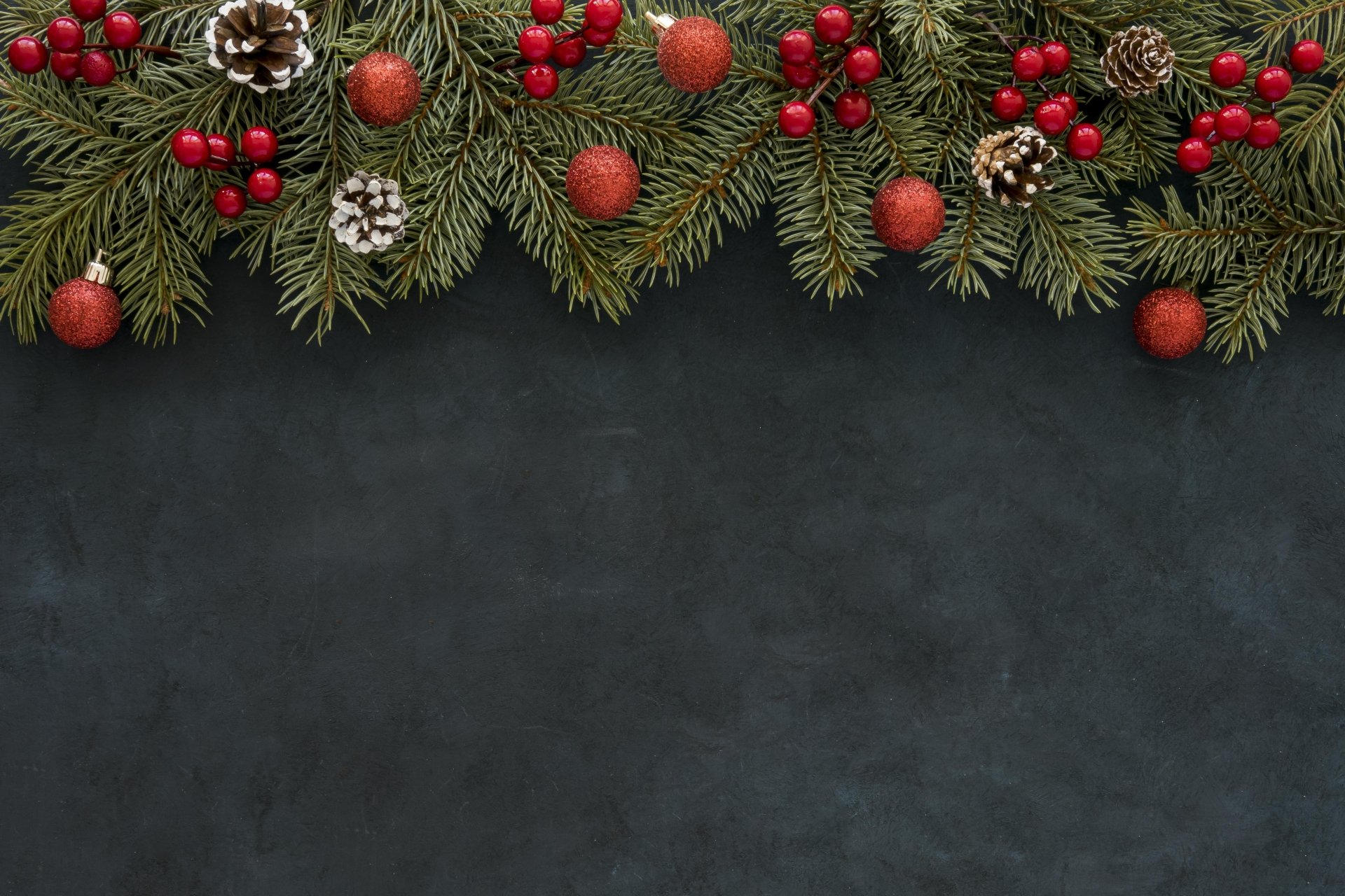 Festive 4K Ultra HD desktop wallpaper featuring a Christmas decoration of spruce cones, red berries, and ornaments arranged along a dark background.