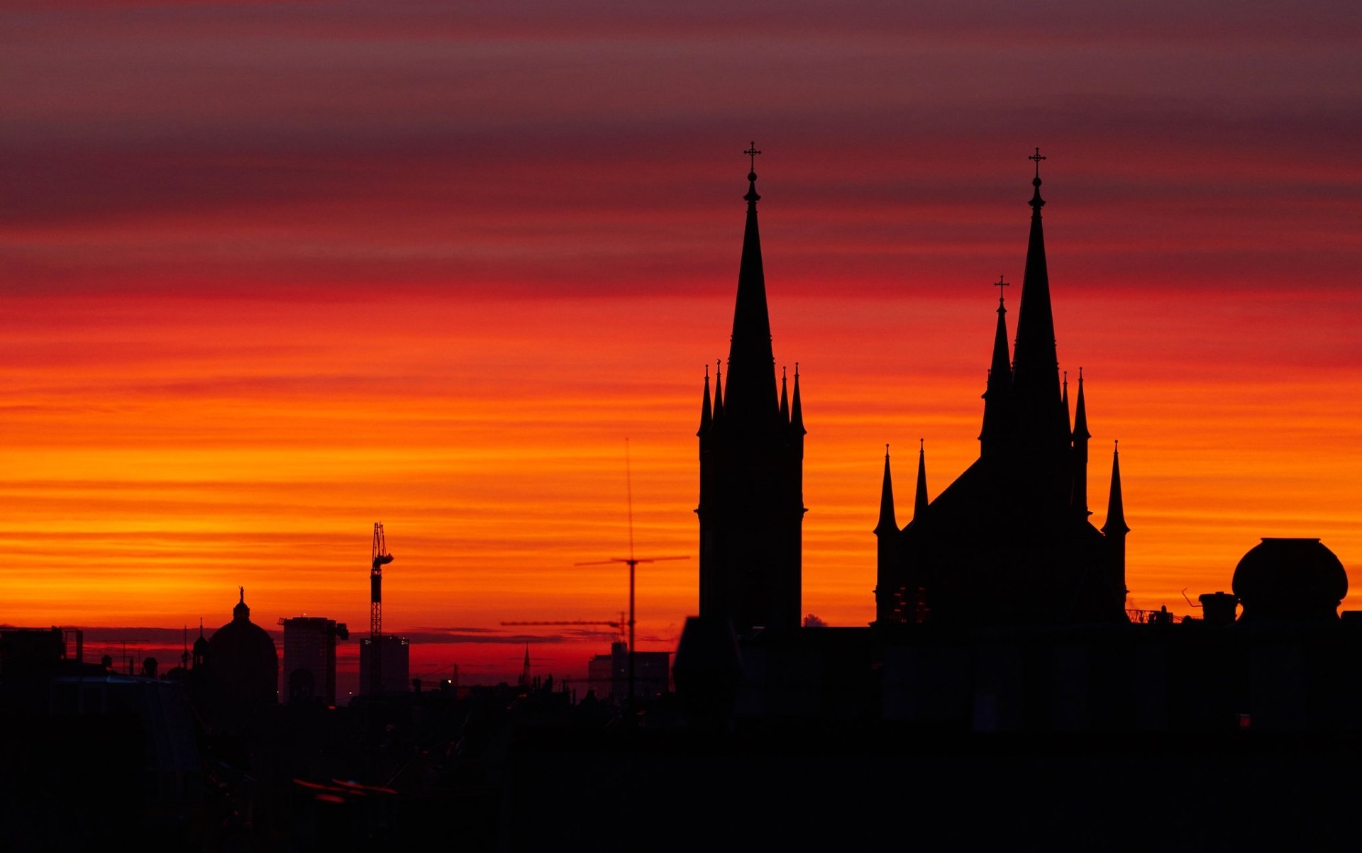 HD PC desktop wallpaper and background: silhouette of Vienna church spires against a fiery orange-red sunset, showcasing Austria's man-made skyline.