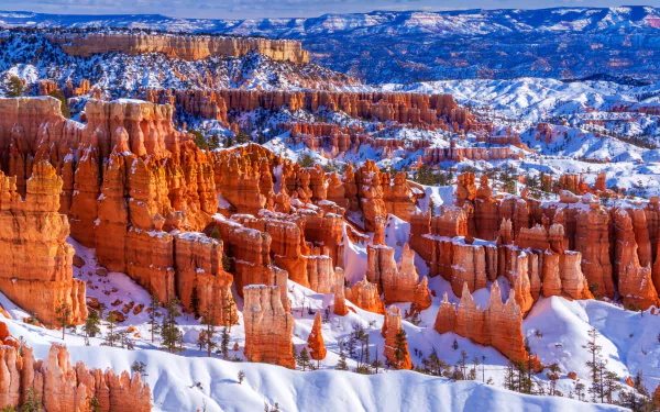 Snow-covered red rock formations at Bryce Canyon National Park, Utah, showcasing a striking winter landscape in the USA.