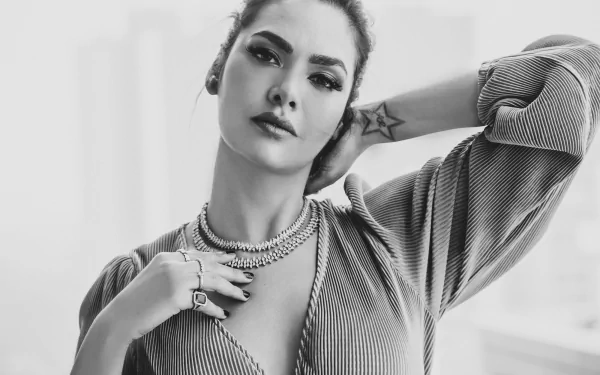 Black and white HD desktop wallpaper featuring Bollywood actress and model Esha Gupta with brunette hair, striking a confident pose.