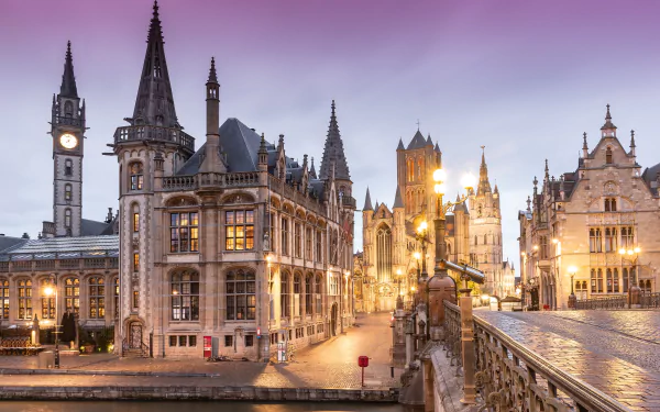 4K Ultra HD view of historic architecture in Ghent, Belgium, showcasing illuminated medieval buildings and cityscape at twilight.