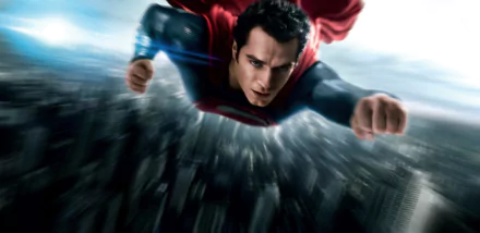 Henry Cavill as Superman in a 4K Ultra HD wallpaper from the movie Man of Steel, shown flying over a blurred cityscape with his iconic red cape.