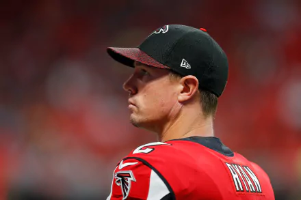 HD desktop wallpaper featuring a profile view of a person wearing a black cap and red Falcons jersey.